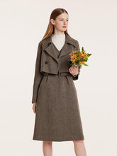 The lady holding the flower is wearing a vintage suit.